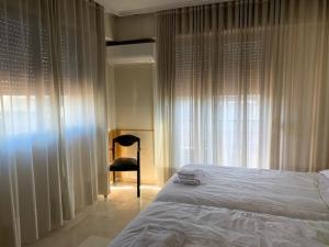 A bed or beds in a room at Apartamentos Torr en Madrid - Chamartín