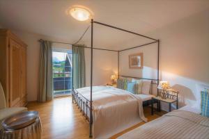 a bedroom with a canopy bed and a window at Chalet Schott in Kirchberg in Tirol