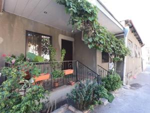 einen Balkon mit Bänken und Pflanzen auf einem Gebäude in der Unterkunft ANAs House in Tbilisi City