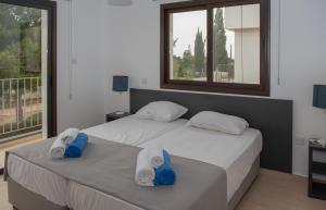 Dos camas en un dormitorio con toallas. en Villa Fortuna, en Ayia Napa 30 fotos más