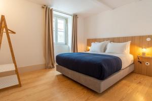 a bedroom with a large bed and a window at FS Boutique Downtown in Lisbon