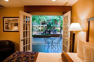 a bedroom with a bed and a view of a patio at Heritage Inn in Great Falls +60 photos