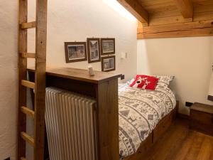 a bedroom with a bed with a radiator and wooden ceilings at Il Cuore della Valdigne - Courmayeur-La Thuile- Pré Saint Didier in Morgex