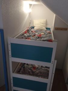a bunk bed in a corner of a room at Corniche de la Plage classé 3 étoiles in Bénodet