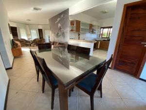 a dining room and kitchen with a table and chairs at Dream Beach Cumbuco Oceanfront Apartments in Cumbuco