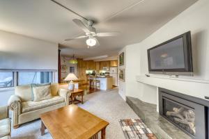 a living room with a fireplace and a flat screen tv at Bridges 61 in Sugarbush Village