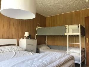 a bedroom with two bunk beds and a lamp at LE VOLPI in Mezzana