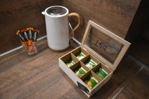 a wooden box with a cup and a drink at Art Apartment 36 in Plovdiv