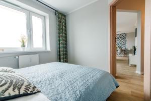 a bedroom with a bed and a window at Leśna#48 in Olsztyn