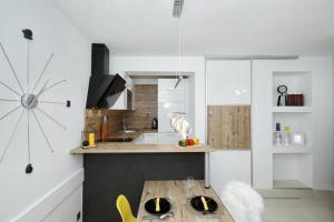a kitchen with a wooden table in a room at Villa Dalmatino in Pakoštane