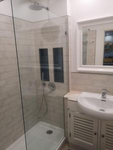 a bathroom with a shower and a sink at Waves Alvor in Portimão