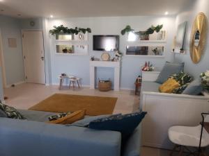 a living room with a blue couch and a fireplace at Waves Alvor in Portimão