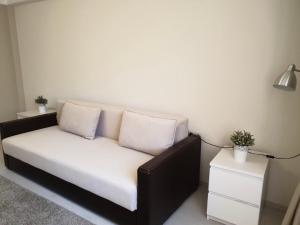 a couch with two pillows on it in a room at Sofia’s Apartment in Chişinău