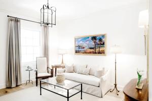 a living room with a white couch and a table at Planters Inn - Charleston in Charleston