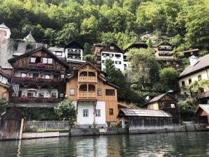 a group of houses on the side of a river at Seehaus am Hallstätter See in Hallstatt