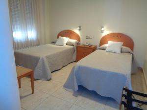Postel nebo postele na pokoji v ubytování Hostal El Retiro