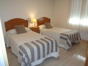Postel nebo postele na pokoji v ubytování Hostal El Retiro
