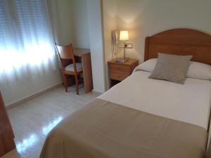 Postel nebo postele na pokoji v ubytování Hostal El Retiro