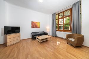 a living room with a couch and a tv at Hotel 26 in Berlin