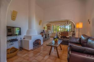 a living room with a couch and a fireplace at Casa Rosa in Luz de Tavira