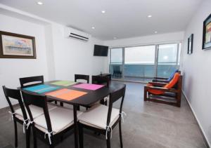 una sala da pranzo con tavolo e sedie e vista sull'oceano di Apartamento en el Sun Rise San Andres a San Andrés