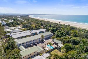 an aerial view of a resort with a beach at Wollongbar Motel in Byron Bay