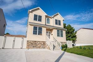 a house with a white fence and a driveway at NEW Luxury Quiet Island Atlantic City Getaway in Atlantic City