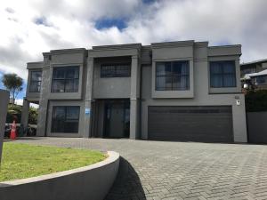 a large house with a garage on a driveway at Lakeview Holiday Hideaway in Taupo