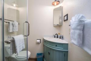 a bathroom with a sink and a toilet and a mirror at Swiftcurrent Lodge in Estes Park