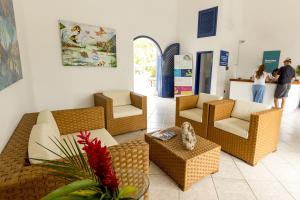 a lobby with couches and chairs and people in the background at Hotel Green 9 & Beach Resort Casablanca in Same +69 photos