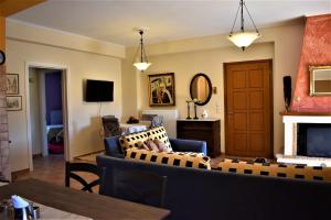 a living room with a couch and a fireplace at Mainades House in Vitina