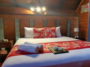 a bed with two towels and a tray on it at Sokala Villas in Muri