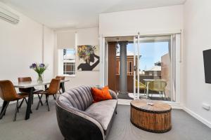 a living room filled with furniture and a window at Terminus Apartment Hotel Newcastle in Newcastle