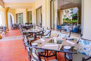 a restaurant with tables and chairs and a patio at Velas Vallarta Suite Resort All-Inclusive in Puerto Vallarta