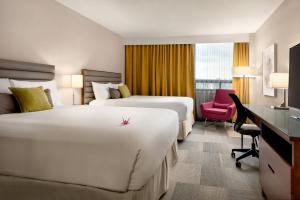 A bed or beds in a room at Coast Prince George Hotel by APA