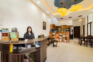 a woman standing at a counter in a store at 5 Coconut Villa in Hoi An +56 photos