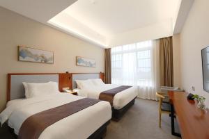 Postel nebo postele na pokoji v ubytování Shanghai Menglong Hotel Management