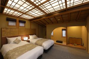 a bedroom with two beds and a skylight at Gion Oyado Kikutani in Kyoto