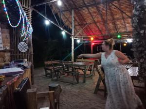 a woman in a dress standing in a room at Mr. Chuoi Bar and Hut in Ko Phra Thong