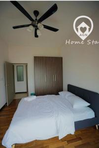 a bedroom with a bed with a ceiling fan at AMAZING SEAVIEW @ SILVERSCAPE in Melaka
