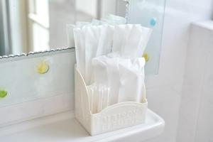 a toothbrush holder sitting on a bathroom counter at Wind Henza in Henza +75 photos