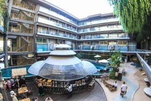 a hotelrium with a pool and a large building at The Crystal Luxury Bay Resort Nusa Dua in Nusa Dua