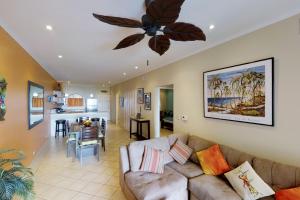 a living room with a couch and a ceiling fan at Sunrise 22 in Tamarindo