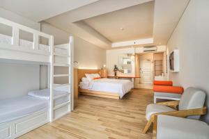 a bedroom with two bunk beds and a desk at HARRIS Resort Batam Waterfront in Sekupang +40 photos