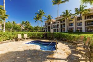 a resort with a swimming pool in front of a building at Shores at Waikoloa #338 in Waikoloa