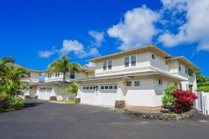 a house with a white fence and a driveway at Plantations at Princeville #1312 in Princeville