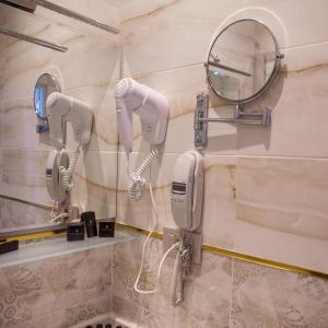 a bathroom with two hair dryers and a mirror at Promenade Hotel Baku in Baku