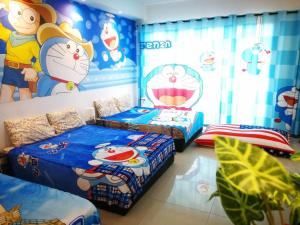 a bedroom with two beds with hello kitty wallpaper at Vince's ICity Soho Homestay water park red carpet shah alam light city central in Shah Alam