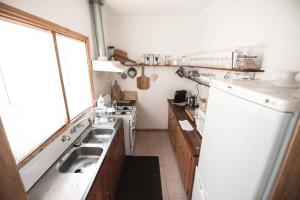 a small kitchen with a sink and a stove at Iris Views - Dromana in Dromana