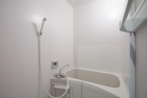 a white bathroom with a shower and a sink at Akabane TK Building 301 in Tokyo +42 photos